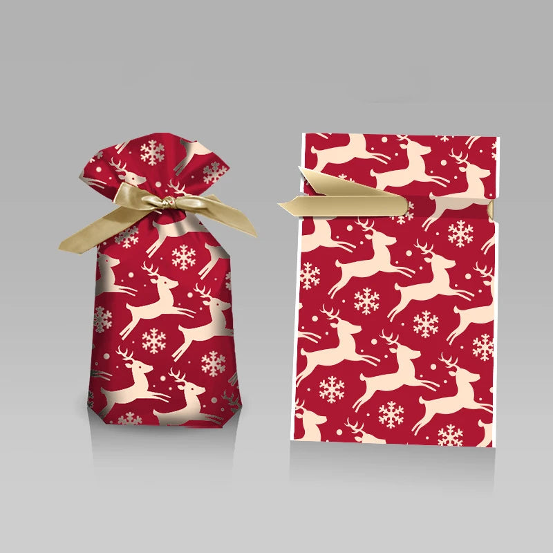 Red gift bag with white reindeer and snowflake pattern on a gray background