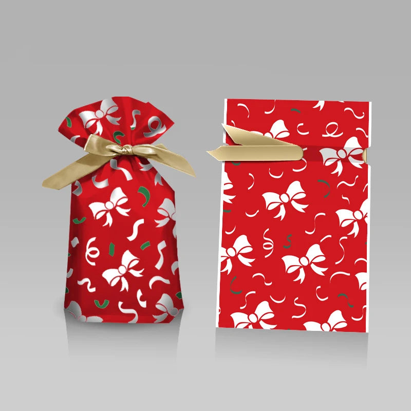 Red gift bag with white bow pattern and gold ribbon on a gray background