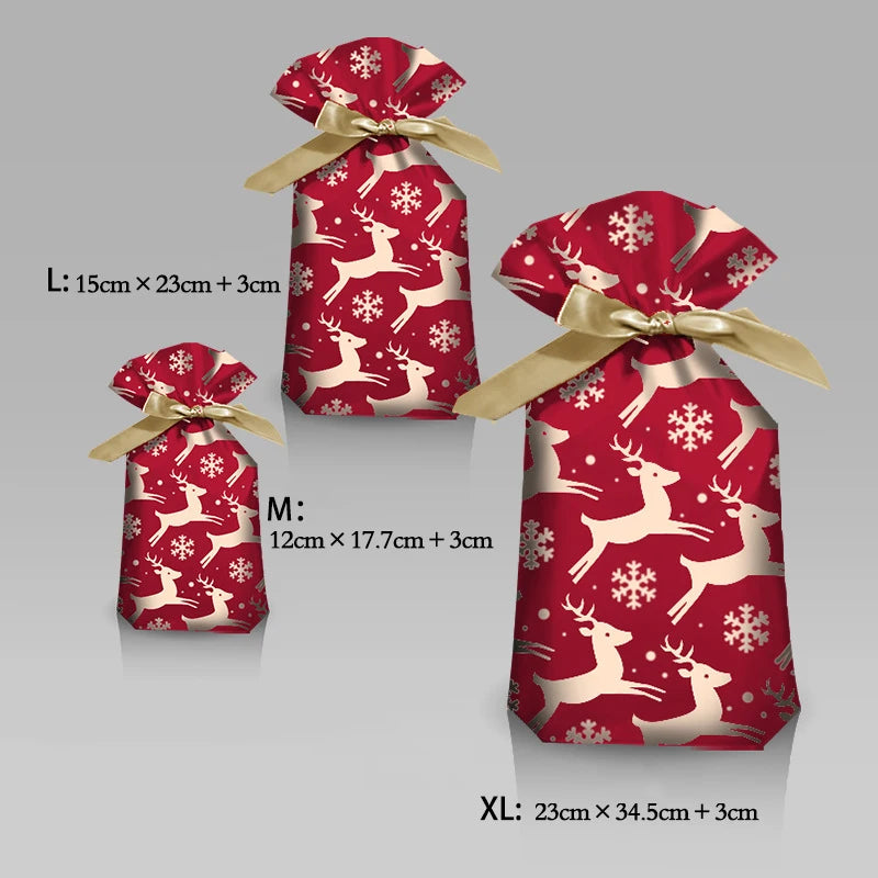 Red gift bags with reindeer and snowflake patterns, tied with gold ribbons, on a gray background.