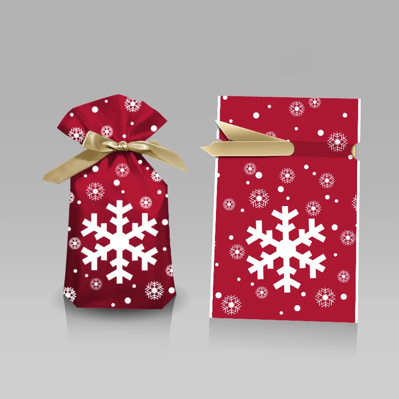 Red gift bag with white snowflakes and a gold ribbon on a gray background