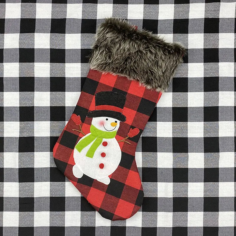 Red and black checkered Christmas stocking with a snowman design on a black and white checkered background.