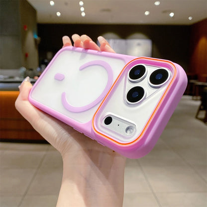 Hand holding a phone case with a smiley face design in a blurred indoor setting