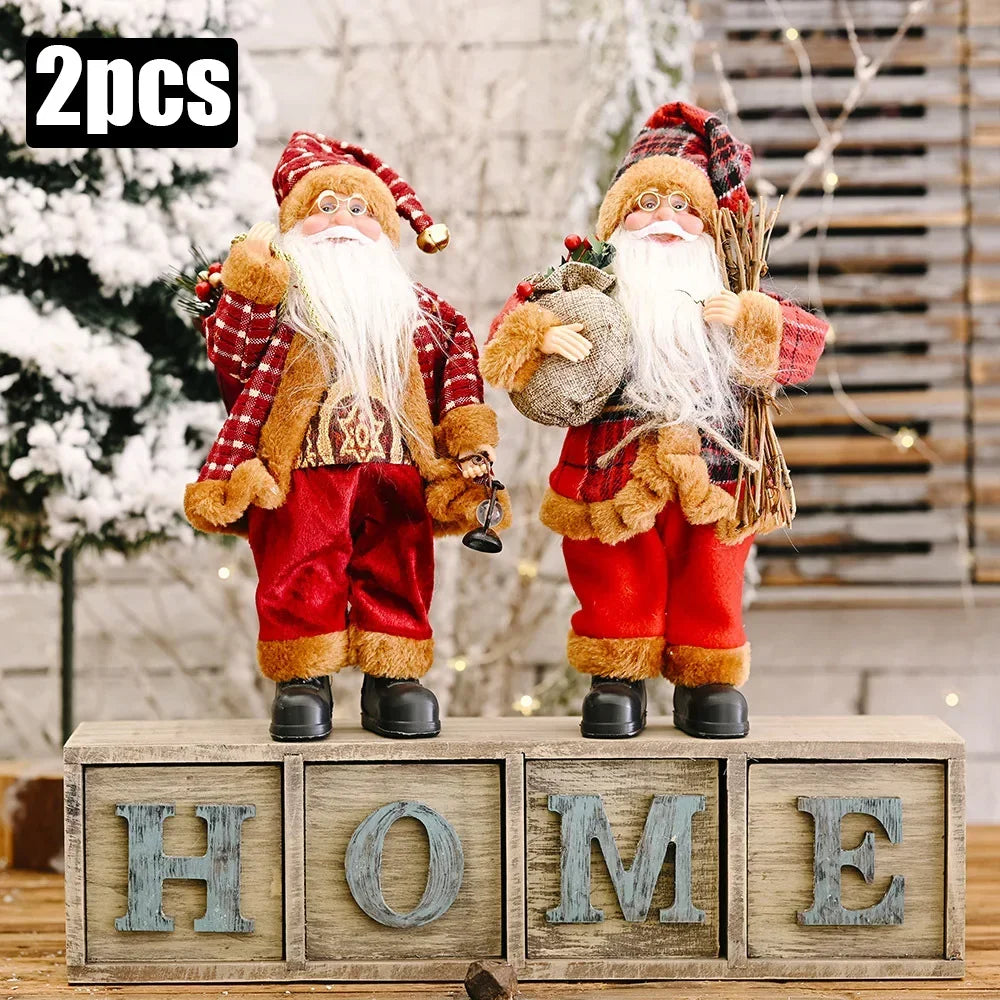 Two Santa Claus figurines on wooden blocks spelling 'HOME' with a festive background.