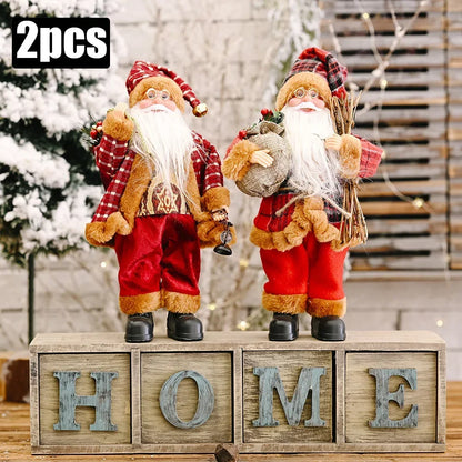 Two Santa Claus figurines on wooden blocks spelling 'HOME' with a festive background.