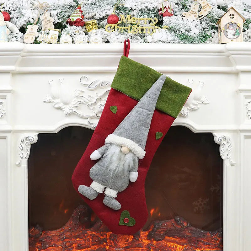 Red Christmas stocking with a gnome design hanging on a fireplace mantle.