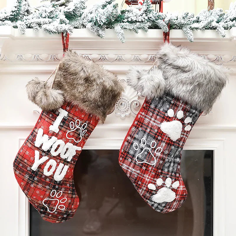 Two Christmas stockings with fur trim hanging on a fireplace mantle.