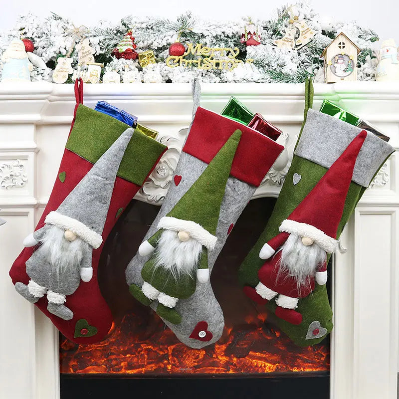 Three Christmas stockings with gnomes hanging above a fireplace.