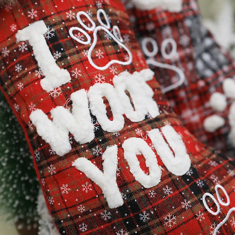Red plaid stockings with 'I WOOF YOU' text and snowflake decorations.