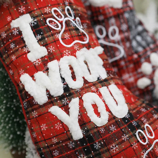 Red plaid stockings with 'I WOOF YOU' text and snowflake decorations.