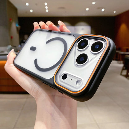Phone case with a smiley face design held in a hand, blurred indoor background