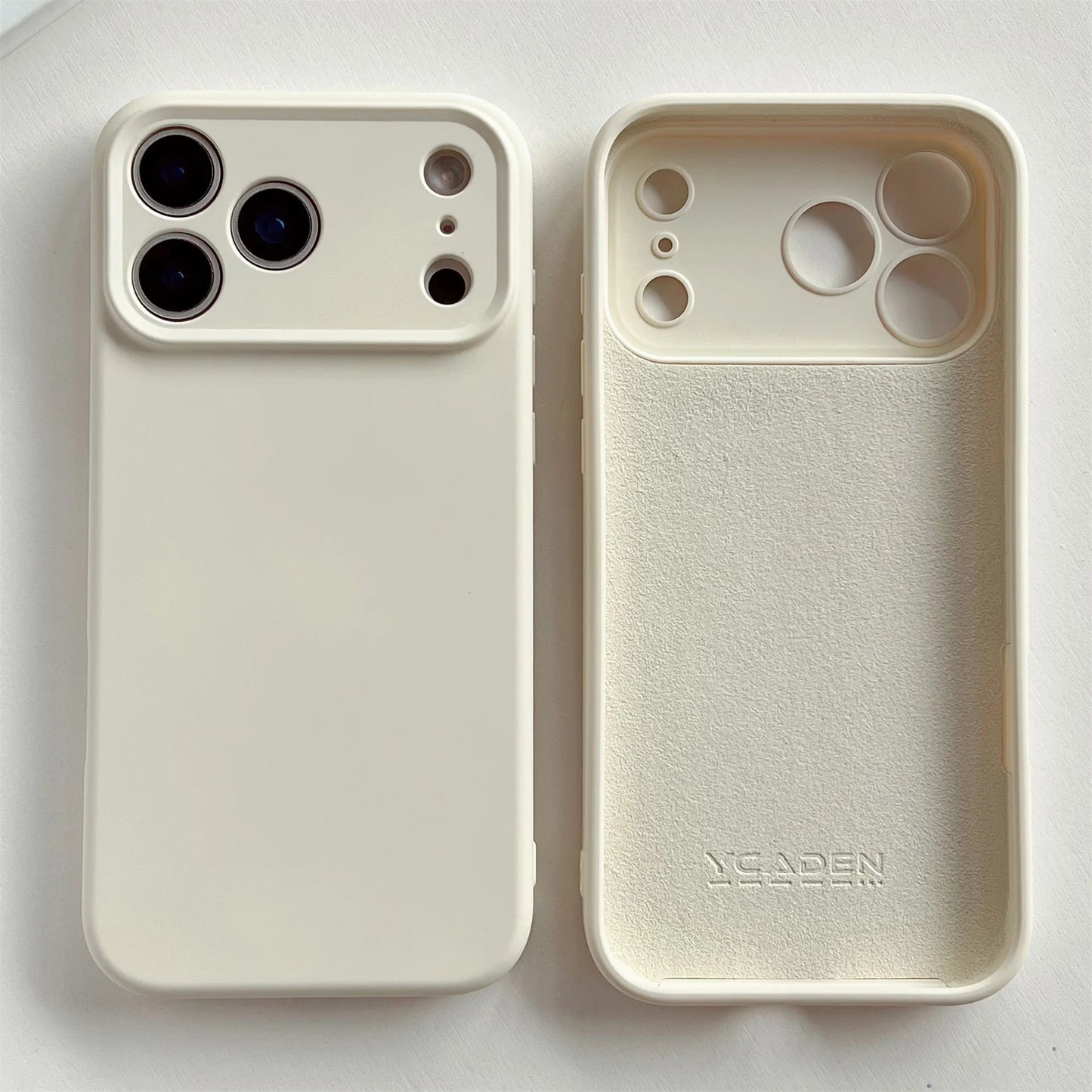Two beige phone cases, one with camera cutouts and the other plain, on a white background.