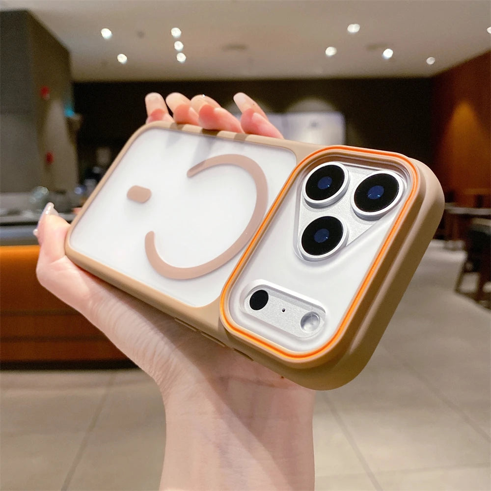 Person holding a phone case with a smiley face design in an indoor setting