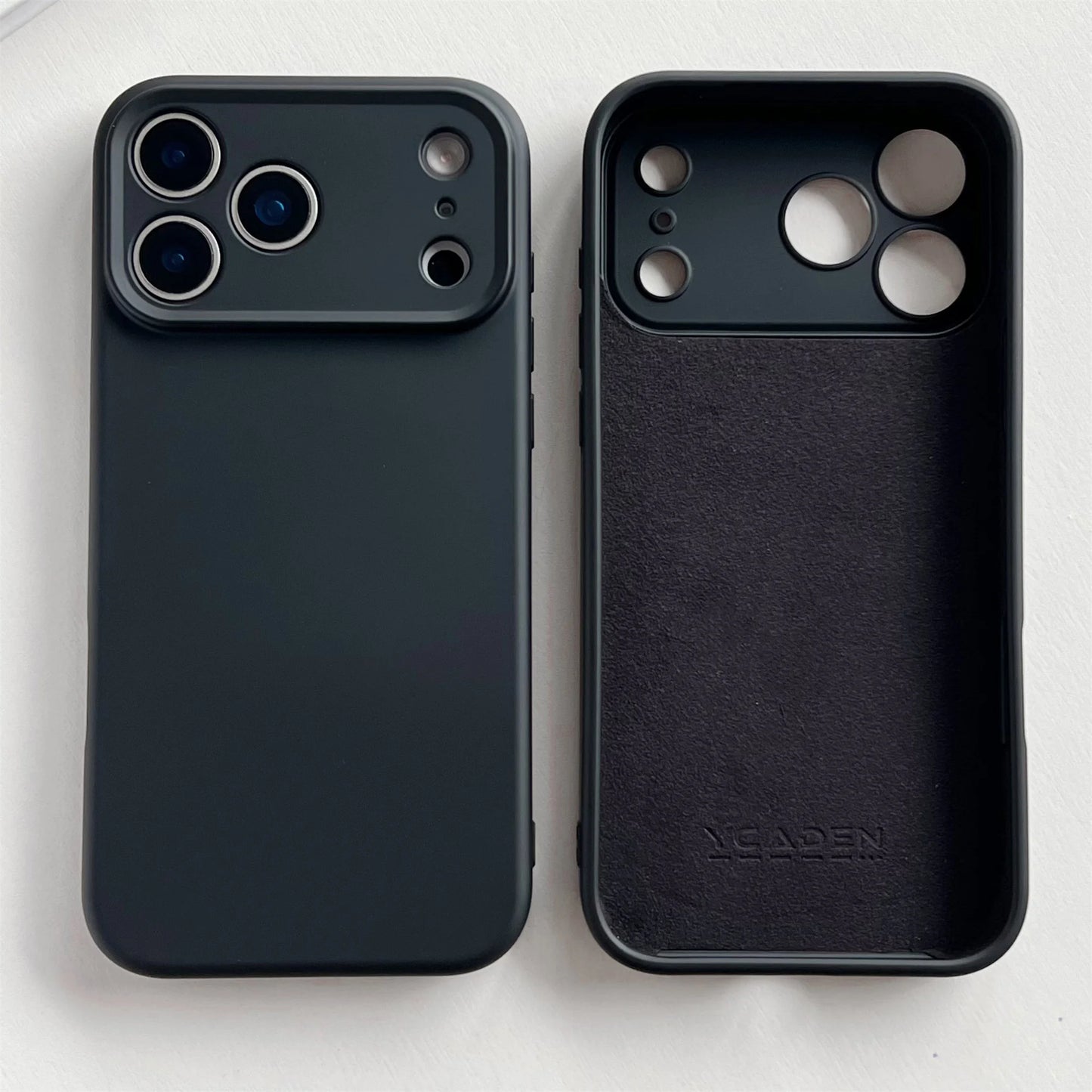 Two black phone cases, one plain and one with a brand logo, on a white background.