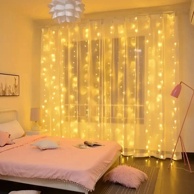 Bedroom with fairy lights draped over a window, creating a warm and cozy atmosphere.