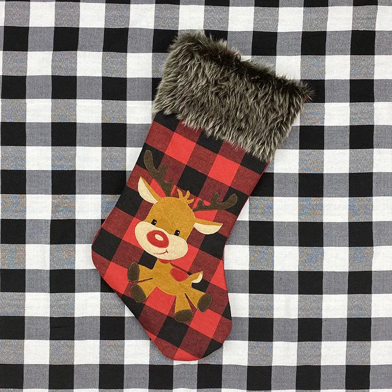 Red and black checkered Christmas stocking with a reindeer design on a black and white checkered background.