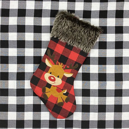 Red and black checkered Christmas stocking with a reindeer design on a black and white checkered background.