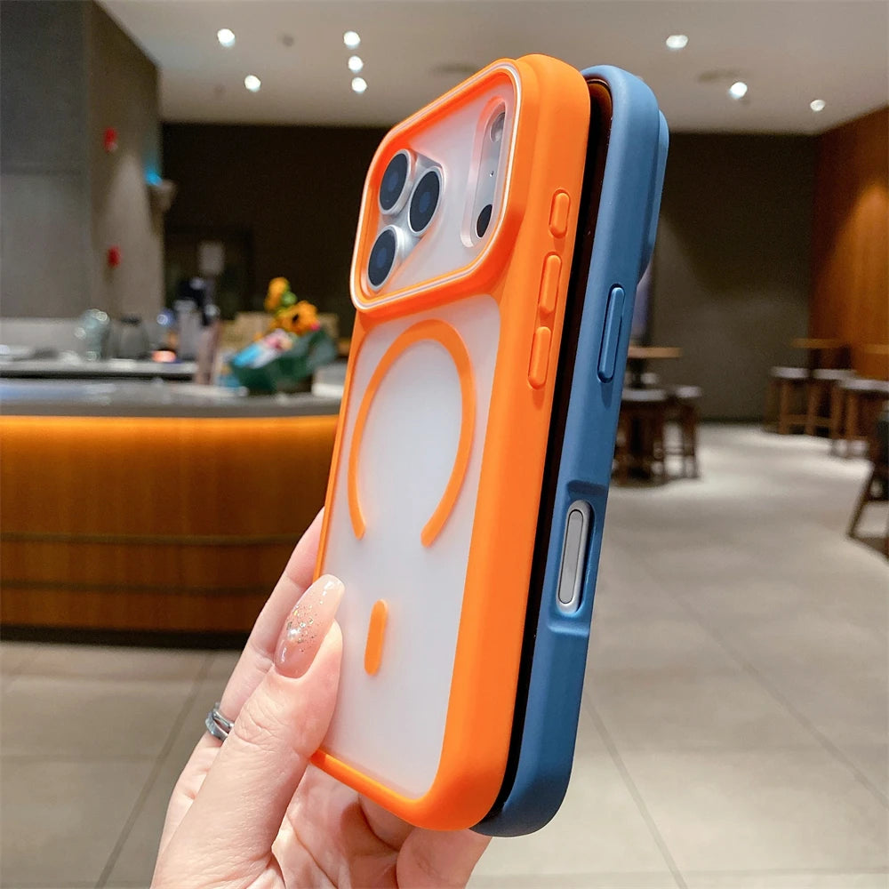 Phone case with orange and blue design held in a hand, blurred indoor background