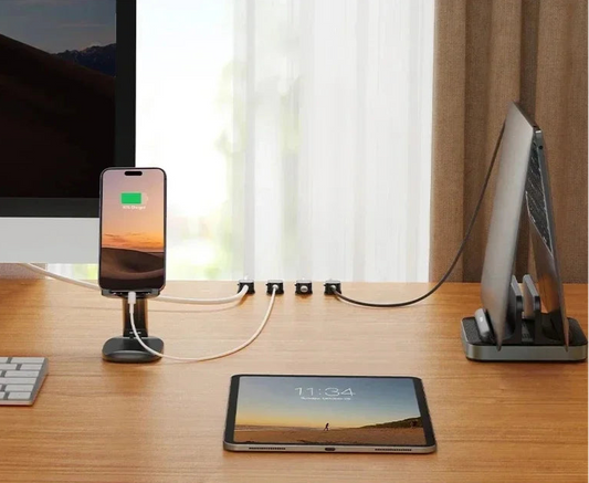 Cable clip holders organizing multiple device charging cables on a clutter-free desk setup