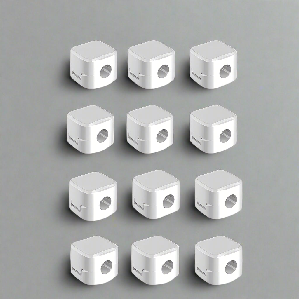 Set of 12 white cable clip holders neatly organized on a table for effective cable management
