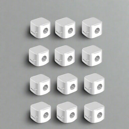 Set of 12 white cable clip holders neatly organized on a table for effective cable management